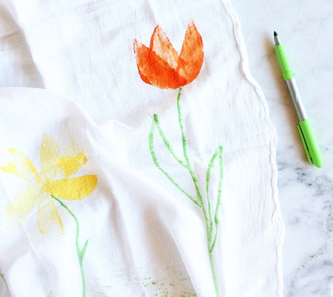 A towel with flowers painted on it.