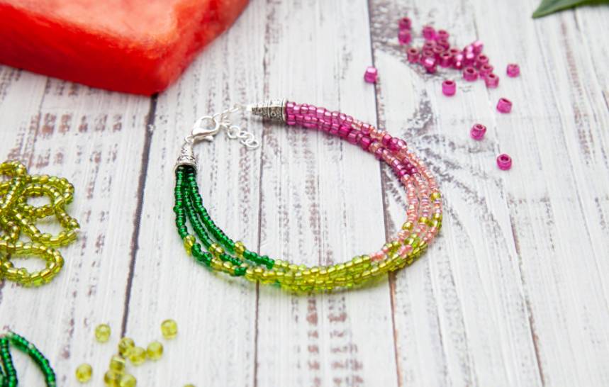 A bracelet with green, pink, and yellow beads.