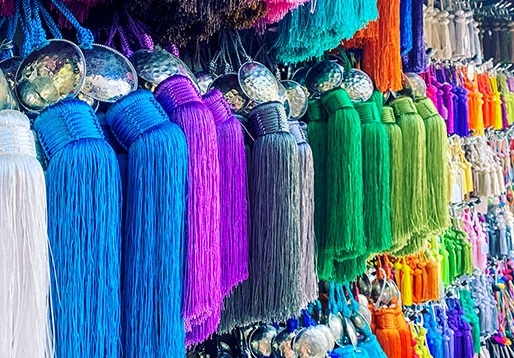 Colorful tassels hanging on a wall.