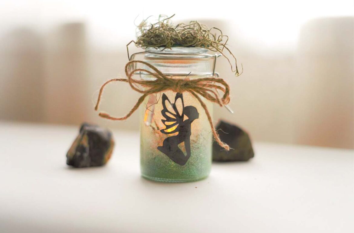 A small glass jar with a fairy in it.
