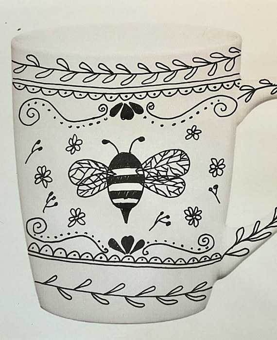 A black and white drawing of a bee on a mug.