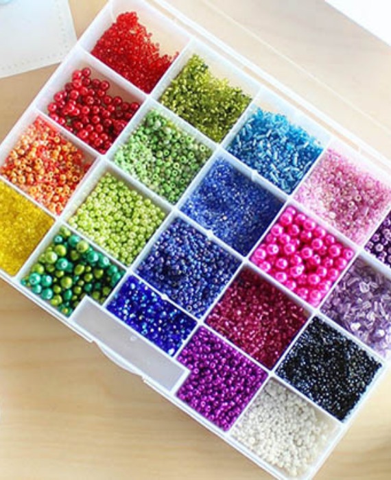 A white box filled with different colored beads.