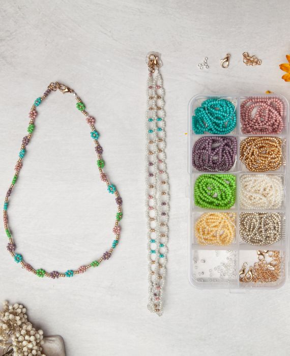 A jewelry making kit with beads, beads, and a box.