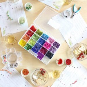 A table with beads and scissors on it.