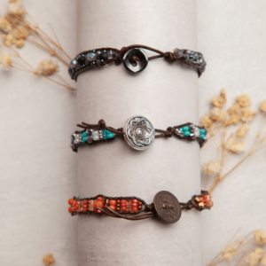 Three beaded bracelets with a button on them.