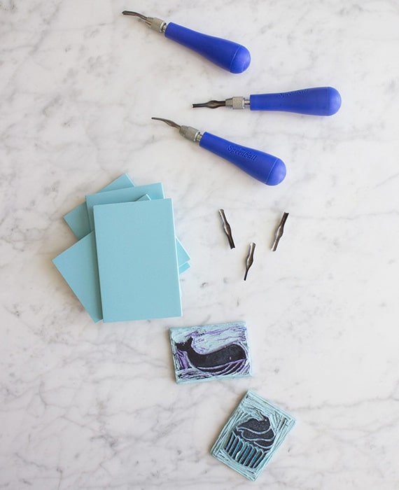 A set of blue stamps and tools on a marble table.