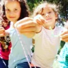 A group of children are holding Kids Jewelry Making Party - Bay Area in their hands.